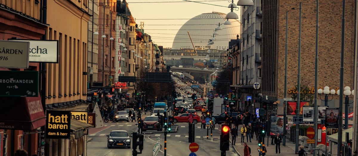 En livlig stadsgata fylld med människor och trafik.